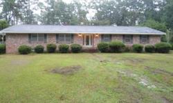 This lovely custom built home is privately nestled on over 7 acres in a great location in Brewton. The home features 3 large bedrooms and a 4th bedroom that was converted into a home office with built-in desks and lots of storage as well as a private