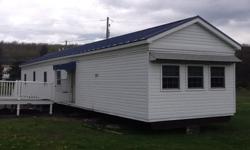 14x70' , 2 Bedroom, Full Bath, all New Double Pain Windows, New Siding, Metal Roof 4 years old, Carpeting throughout 4 years old. Large living room, open kitchen with snake bar and additional enclosed sunroom. All Electric Heat, New 200 amp Service