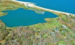 This property covers over four acres of Squires Pond waterfront, and it abuts, to the west, a large parcel of land that cannot be developed, ensuring future privacy. Other features include beautiful, protected views of Peconic Bay and the North Fork, as