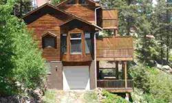 Perfect mountain home or vacation getaway on almost 3 acres of trees and large boulders with breathtaking views. Cozy, covered front porch and three decks for easy outdoor living. Custom designed two story cedar mountain contemporary design, lots of