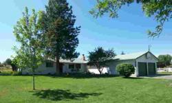 This west-side country home is located on 3 irrigated acres at the end of a quiet cul-de-sac, just a few minutes from town. The bright and open kitchen sits adjacent to the dining room with the living and family rooms just around the corners. 4 bedrooms,
