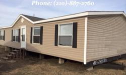 This 2001 Spirit Double-wide Manufactured Home, Century Model, has a lovely fireplace with 4 bedrooms and 2 bathrooms. The counters are table-topped with granite and wood style. Garden tub and stand alone shower in the master bathrooms for the up most