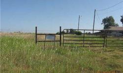 10 acres, mol. Address is a 'guessitmate'. Water well on northwest part of the property, no pump, condition unknown. Oil well on property approx 3/4 way back, close to W side. Graveled oil field road easement along E side of property. Fenced on W and S
