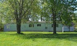 Wonderful setting describes this property with its mix of fruit trees, partially fenced in back yard. Enjoy peaceful living in this well kept 3 bedroom mobile home with addition and partial basement. 12x15 deck, 12x16 shed, and 26x36 heated
