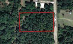 Nicely wooded 165 x 300' country lot, located just off the paved road, zoned for mobile homes or house, animals welcome. The back half of this lot shows up on the low lot list. Buyer is responsible for all improvements, including well, septic &